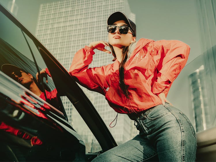 
A Woman Wearing A Windbreaker And Denim Pants