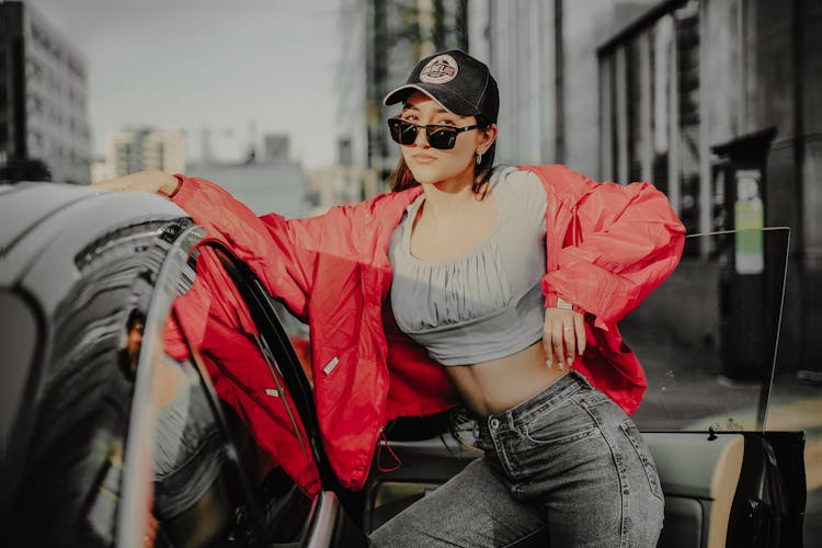 
A Woman Wearing A Windbreaker And Denim Pants