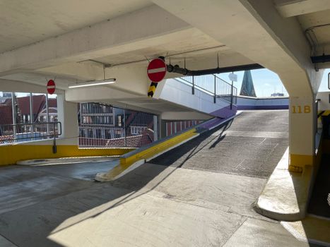 Bright view of an indoor parking garage ramp with cityscape in Bremen, Germany.