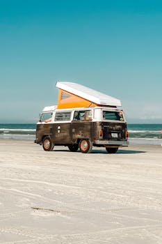 A classic vintage van parked on the sandy shores of New Smyrna Beach, Florida.