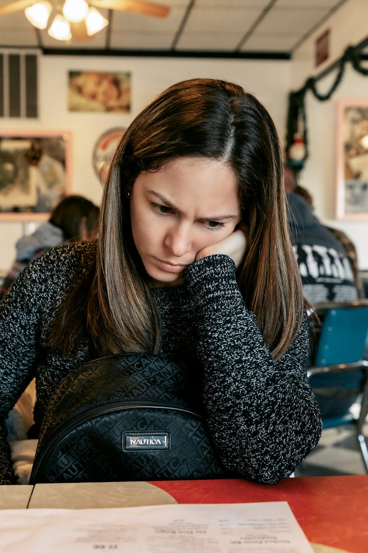 A Woman Looking At A Restaurant Menu