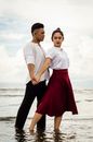A Couple Holding Hands and Dancing at the Shore