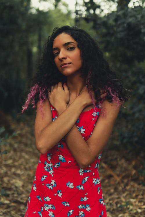 Photo of a Woman Wearing Red Floral Dress