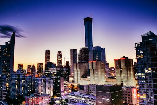 Vibrant cityscape of Beijing's skyline with illuminated skyscrapers at dusk.