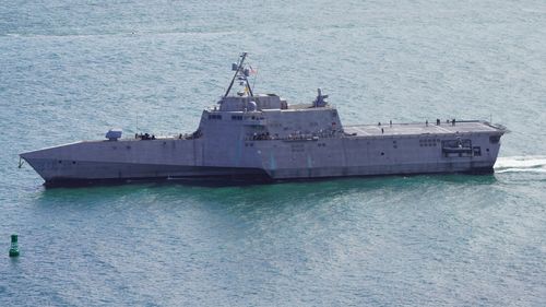 Free Aerial shot of a modern navy warship cruising through San Diego Bay under clear skies. Stock Photo