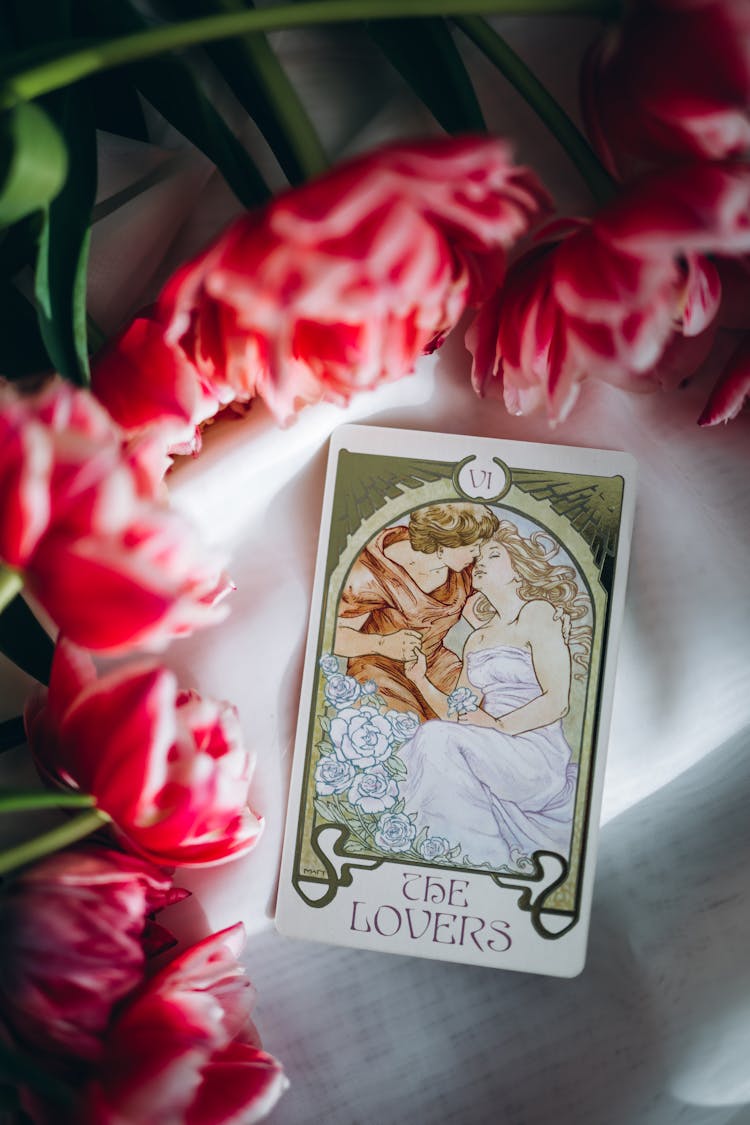 Tarot Card Among Red Tulip Flowers