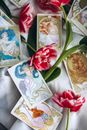 Tarot Cards Lying Among Red Tulips