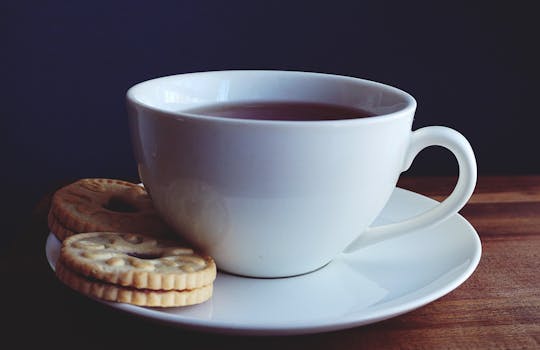 Close-up Photography of Cup of Coffee Near Biscuits