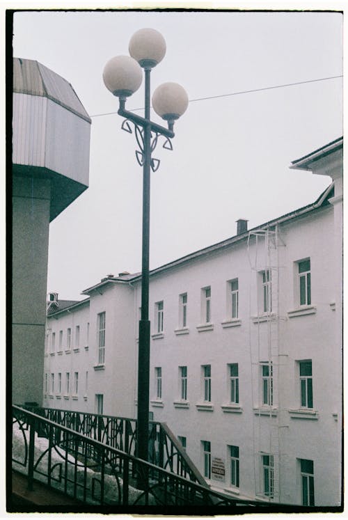 A Lamppost Near Beside the Metal Railings on the Street