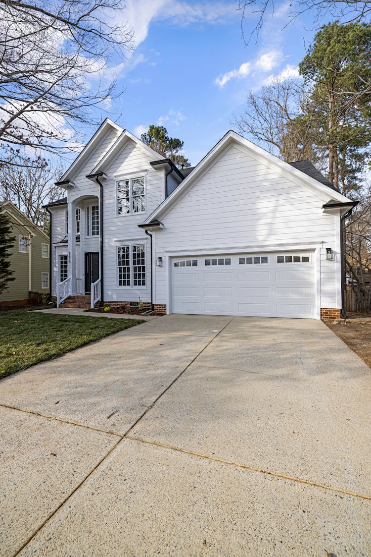 Beautiful White Wooden House Near Bare Trees