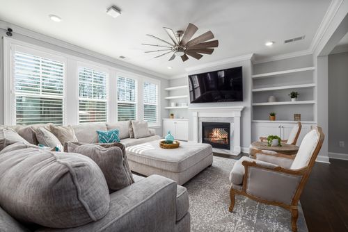 Free Bright and elegant living room featuring a fireplace and comfortable seating. Stock Photo