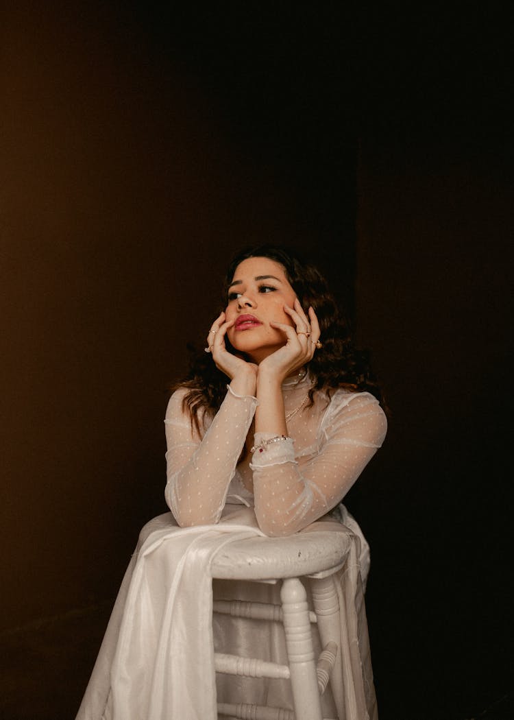 Woman Resting Elbows On Stool