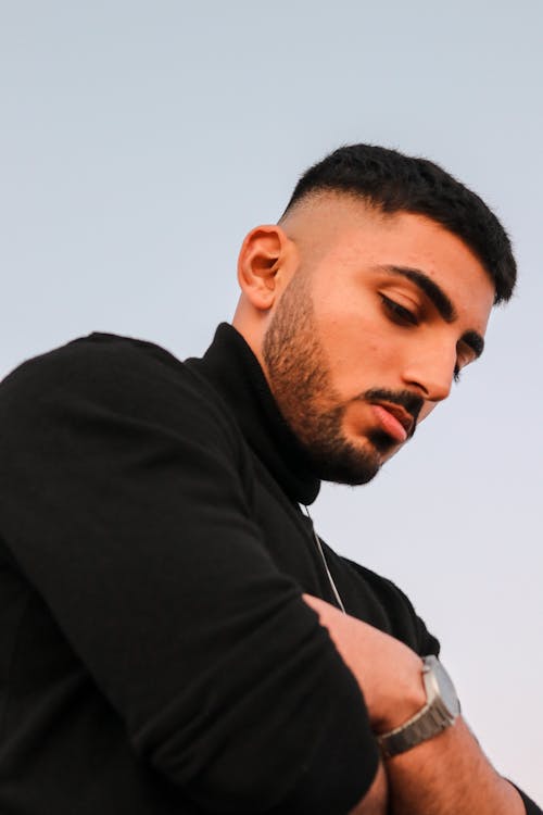 Young Man with Stubble Over Blue Sky