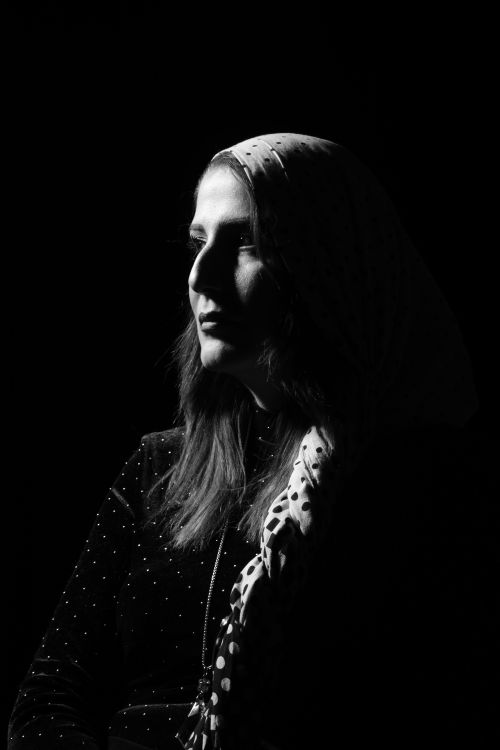 Free Striking black and white portrait of a woman wearing a scarf, showcasing strong contrast and mood. Stock Photo
