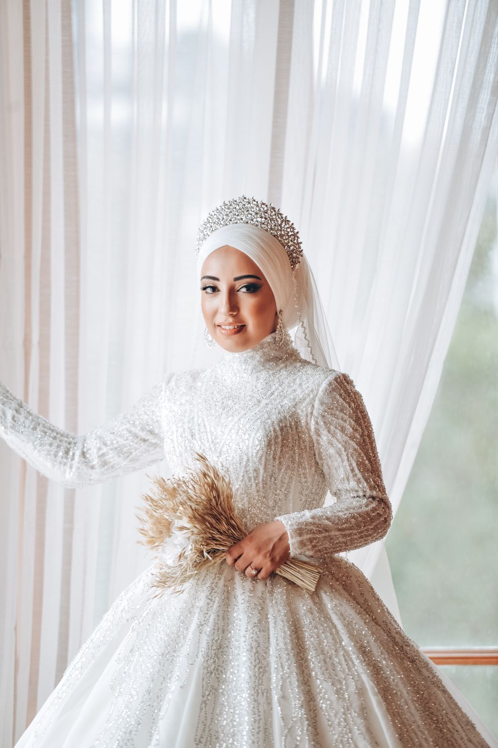 Bride in an ivory wedding gown, soft indoor light