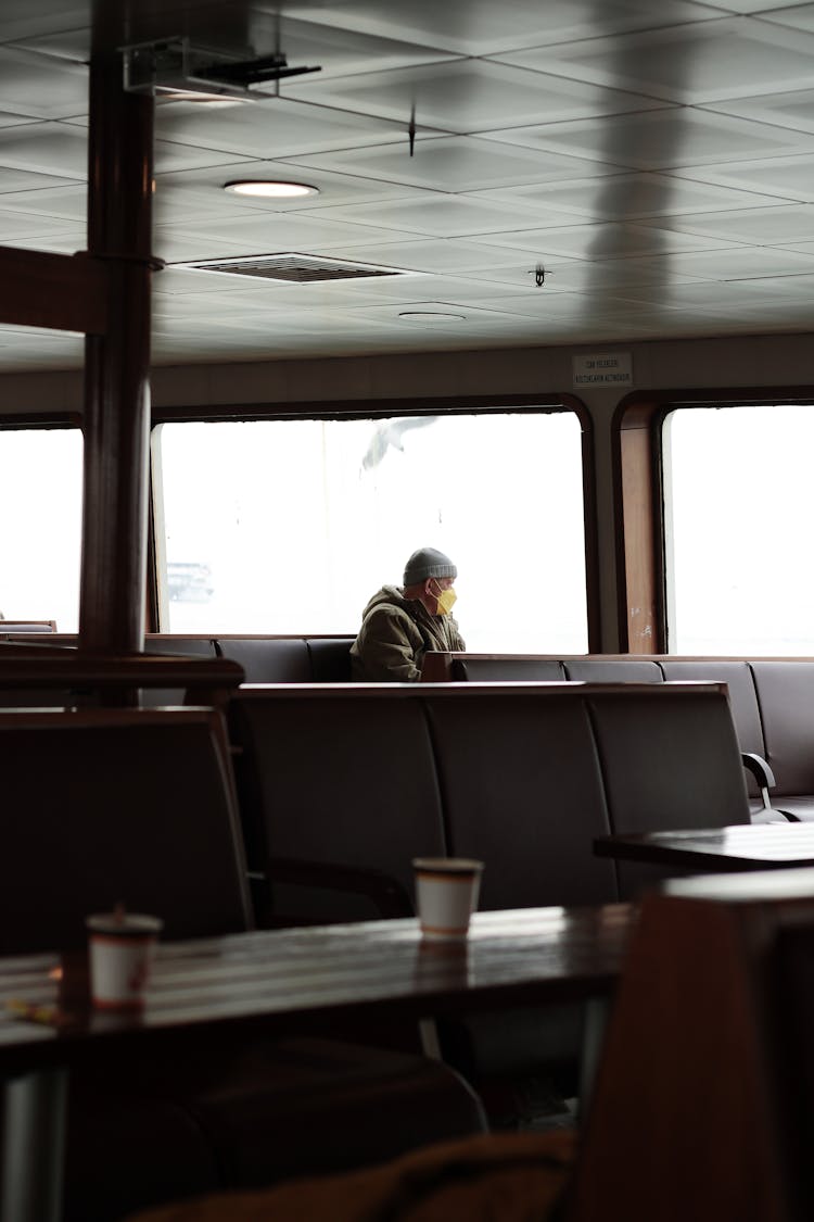 Man With Mask In Ship's Cafeteria