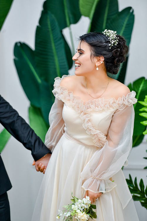 Beautiful Bride Holding Hands with the Groom 