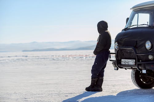 Man Standing near Truck in Snow