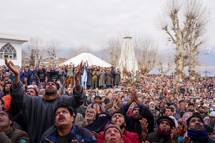 Crowd Praying With Arms Raised