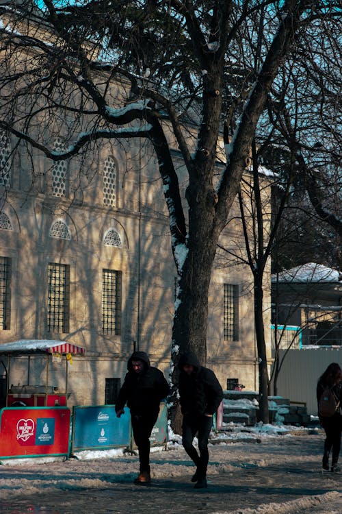 People Walking on Sidewalk Near Building