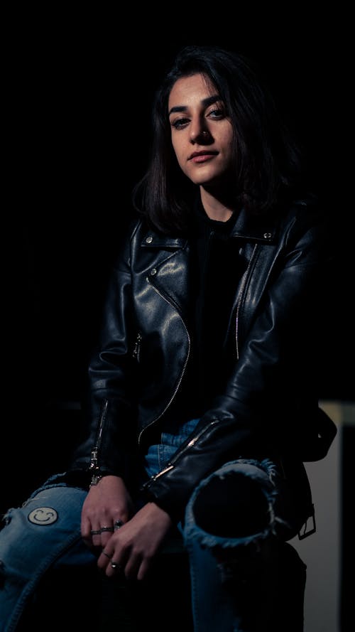 Woman in Black Leather Jacket and Blue Denim Jeans