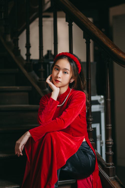 Free 
A Woman in a Red Dress Sitting on a Stairs Stock Photo