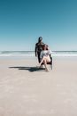 Woman in Black Jacket Sitting on Womans Lap on Beach