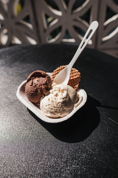 A Bowl of Flavored Ice Cream on a Black Surface