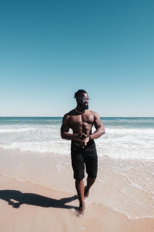 Free Muscular African American man enjoying a sunny day at St. Augustine Beach, Florida. Stock Photo