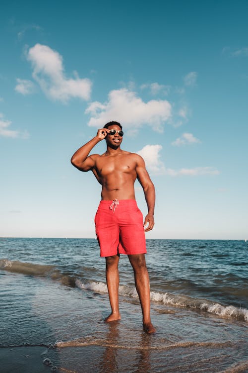 Shirtless Man In Swim Trunks And Sunglasses Free Stock Photo and