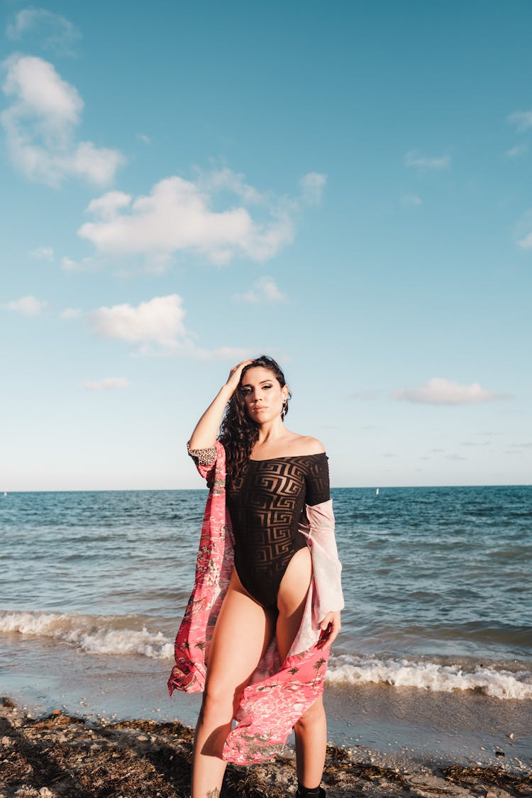 Woman In Bikini Standing On Beach Shore