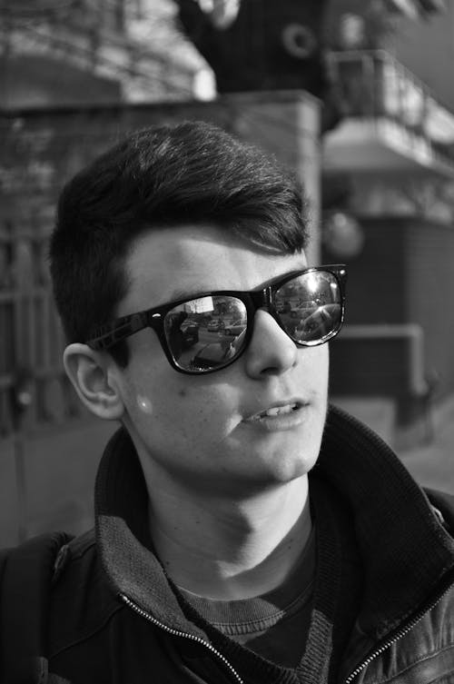 

A Grayscale of a Man Wearing Sunglasses