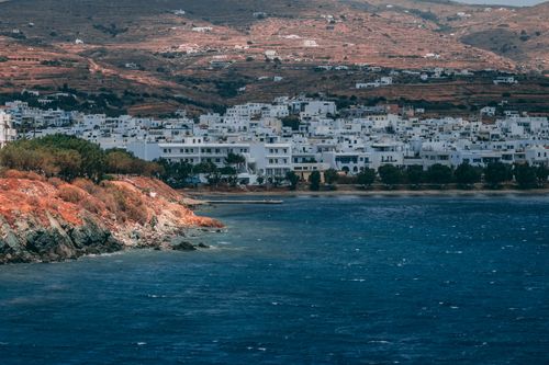 Free Scenic view of a coastal town with white buildings by the deep blue ocean. Stock Photo