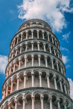 Close-up of the iconic Leaning Tower of Pisa under a clear blue sky. Perfect for travel and architecture lovers.