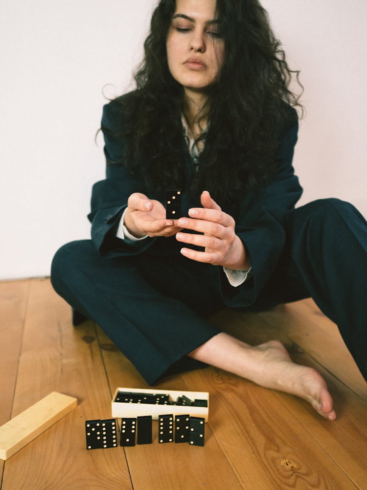 Woman Holding Domino Tiles 