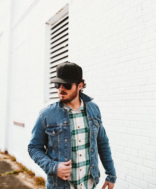 Free Young Man in Sunglasses in Denim Jacket and Black New Era Hat Stock Photo