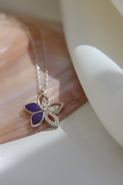 Silver Necklace with Flower Pendant in Close-up Photography