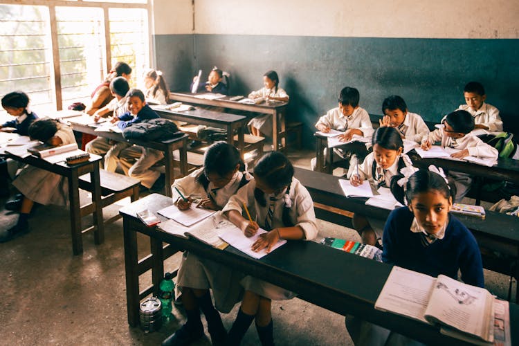 Students Busy Doing Their Seatwork Inside The Classroom