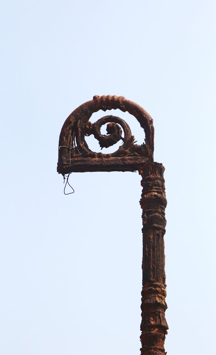 A Rusty Post Under Blue Sky