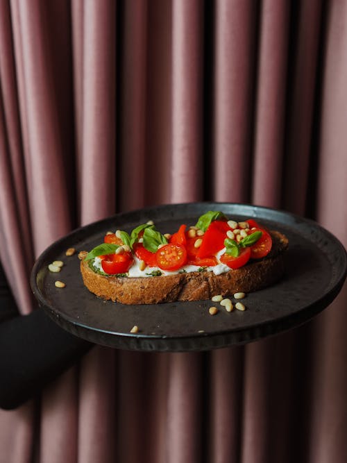 Appetizing Toast with Red Tomatoes Served on Pan by Unrecognizable Person