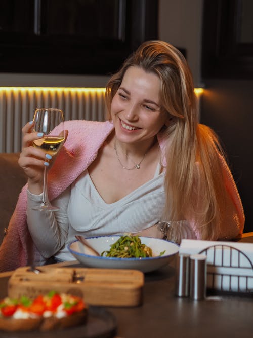 Woman in Pink Cardigan Holding Wine Glass