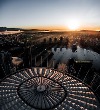 Captivating aerial view of Vancouver at sunrise, highlighting BC Place Stadium and the cityscape.