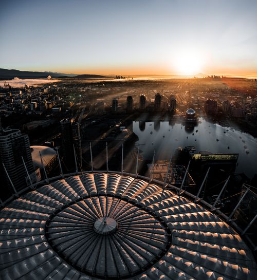 Free Captivating aerial view of Vancouver at sunrise, highlighting BC Place Stadium and the cityscape. Stock Photo