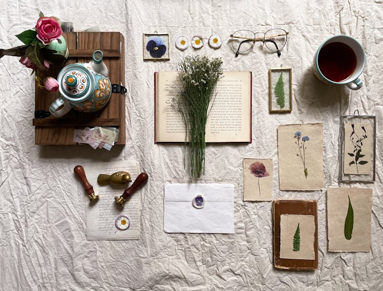 Flat Lay Of Vintage Items And Flower Paintings