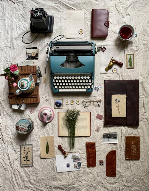 Retro Typewriter and Accessories on White Fabric 