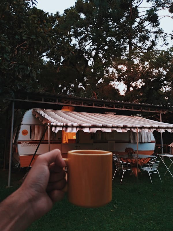 Person Holding Orange Mug