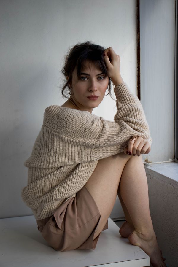 woman in camel ribbed knit matching set at a modern restaurant