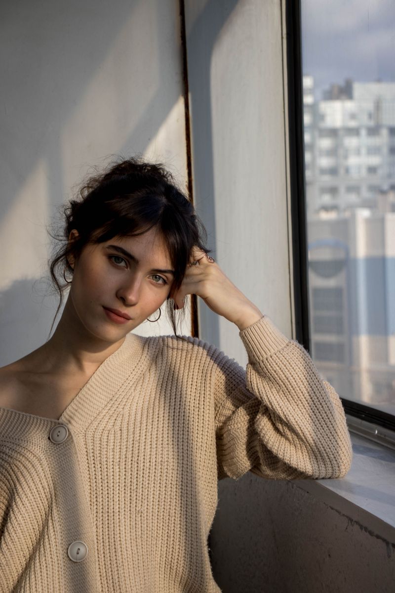 woman in a beige cardigan over a dress
