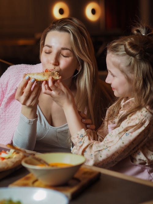 Free Girl Feeding a Woman Stock Photo