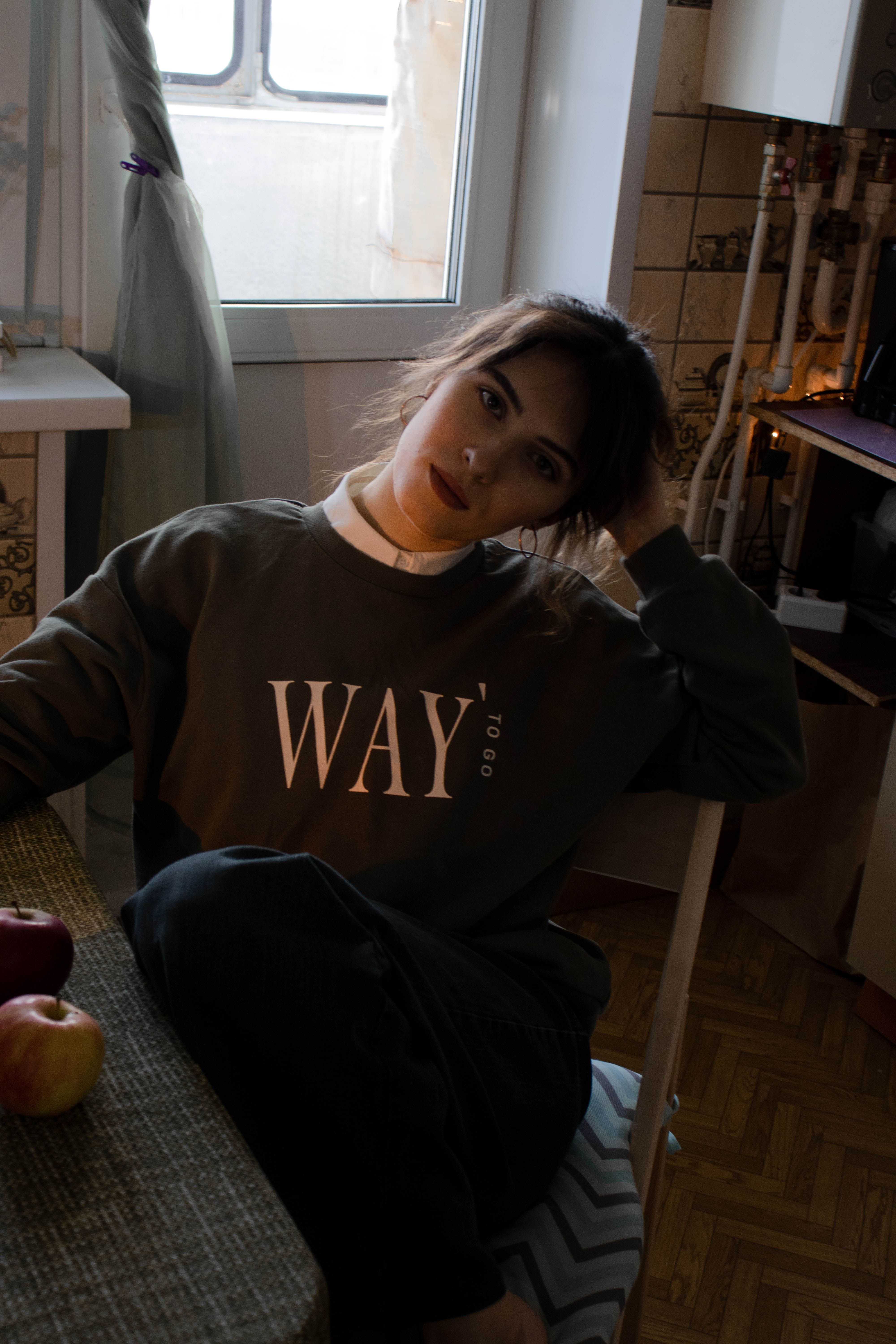 A Woman in a Sweater Sitting on Chair · Free Stock Photo